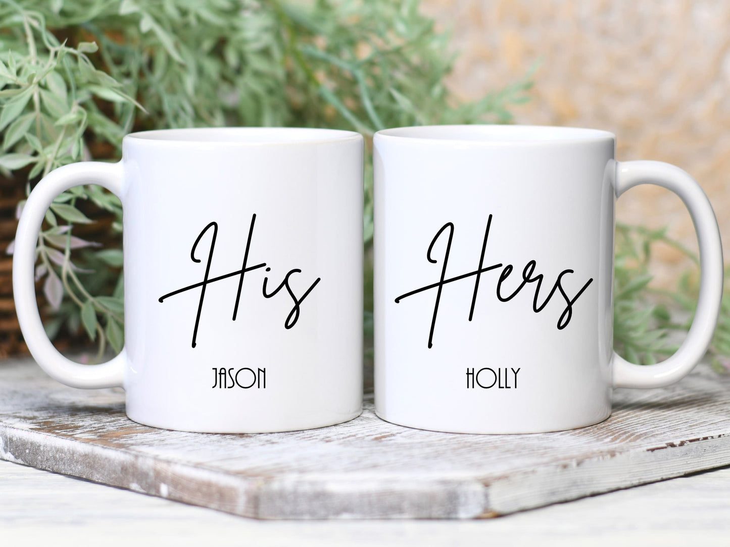 set of two white mugs. One has the text His in a script font with a name below and the other has Hers with a name below.