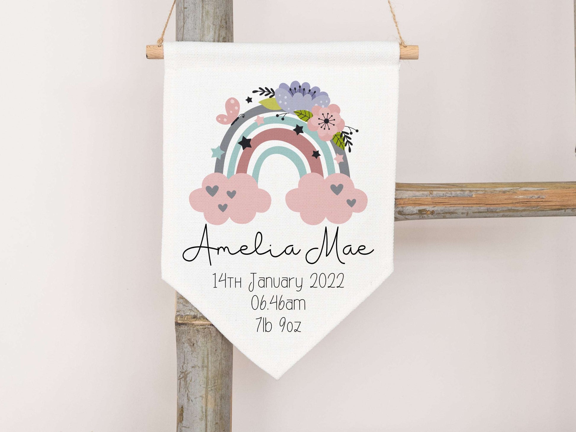 linen flag with floral rainbow design printed on with a name and birth details below