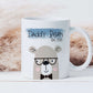 white mug with a boho theme behind. The mug has a bear illustration that is wearing black glasses and bow tie with the text daddy bear est. 2022 printed above over a blue brushstroke.