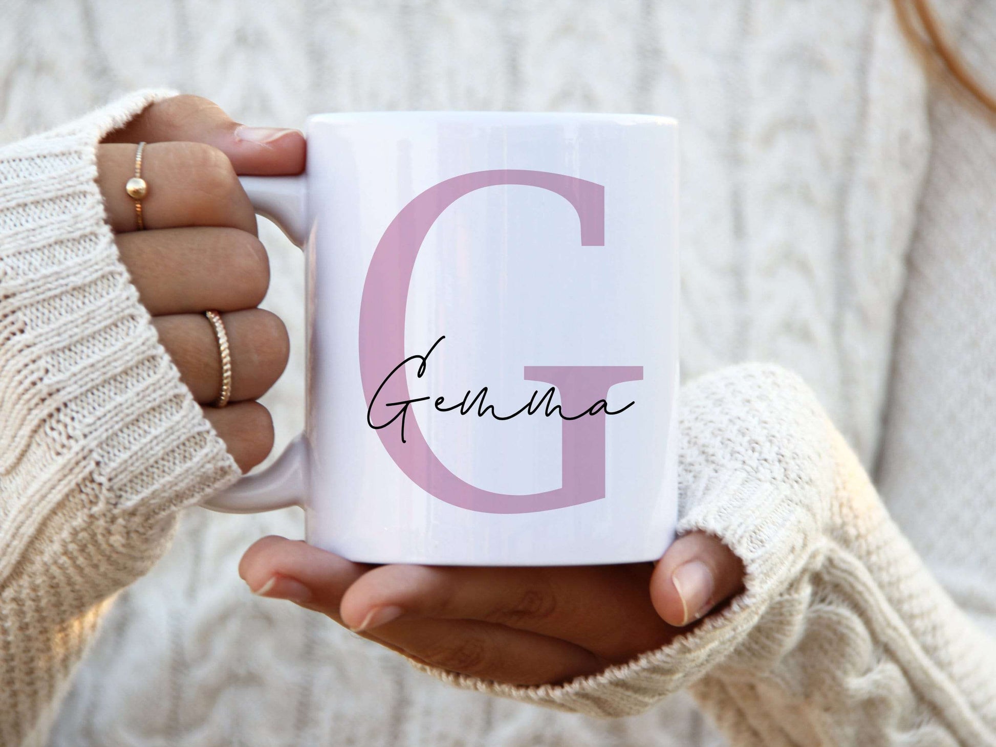 woman holding a white mug with a large pink letter G with the name Gemma printed over in a script font.