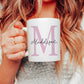 woman holding a white mug with a large pink letter M printed on and the name maddison printed over in a script font