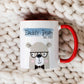 cute bear design printed on a white mug with red handle. There is Daddy bear printed above the design over a blue banner. The mug is on a cream knitted blanket