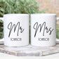 set of two white mugs. One has Mr printed on in a script font with a surname below. The other has Mrs printed on