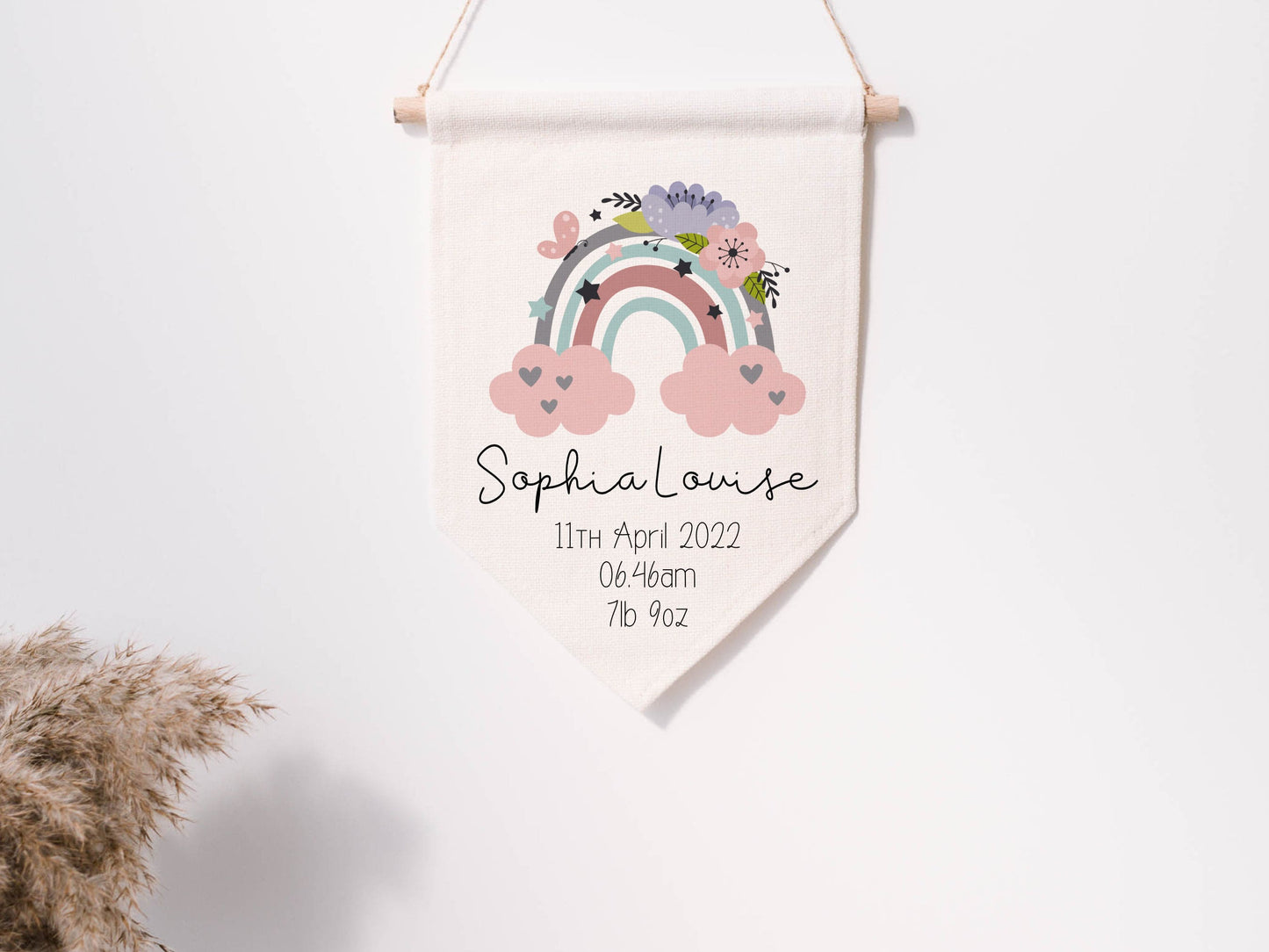 linen flag with floral rainbow design printed on with a name and birth details below