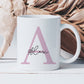 white mug with a large pink letter A and the name alex printed over in a script font