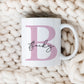 personalised pink letter mug with the name Becky printed over in a script font. The mug is on a cream knitted throw